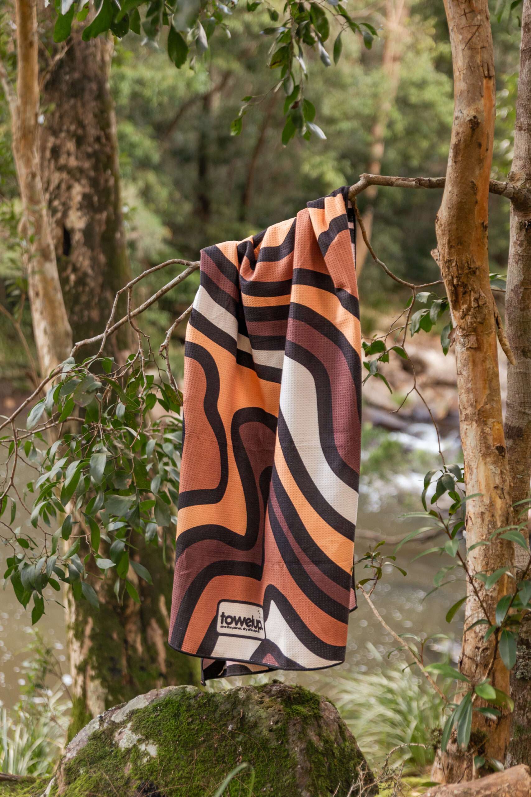 Latte Lounge pastel coffee sand free Beach towel hanging from tree.