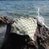 Beach towel on a rock by the sea
