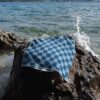 Beach towel on a rock by the sea