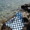 Beach towel on a rock by the sea