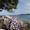 Beach towel hanging over a rock by the sea