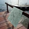 Beach towel on a rail by the sea