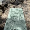 Beach towel on a rock by the sea