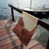 Beach towel on a rail by the sea