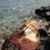 Beach towel on a rock by the sea