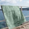 Beach towel on a rail by the sea