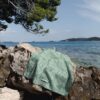 Beach towel on a rock by the sea