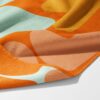Retro Bloom colourful gym towel – white background, zoomed in bottom right, corner folded to show reverse