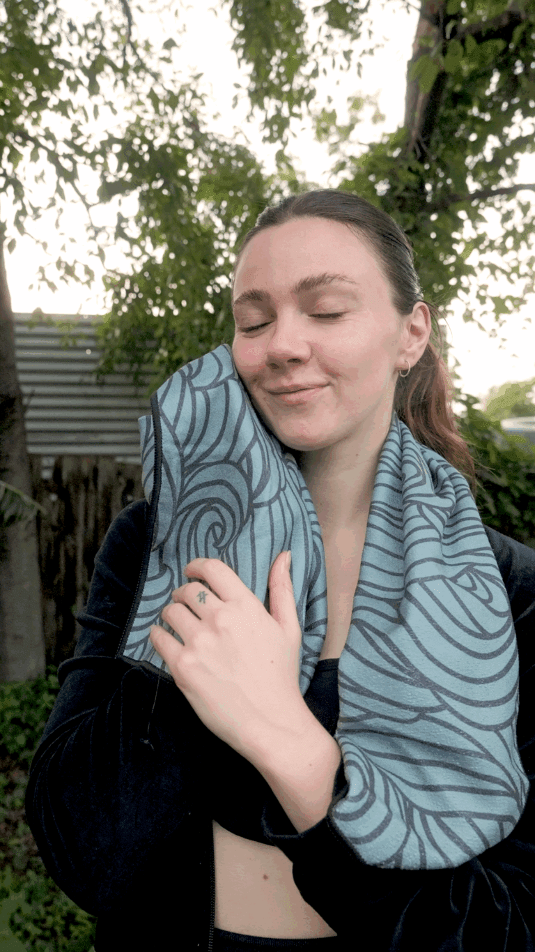 Gym towel being held up to the face to show softness